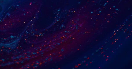 Fluorescent background. Blur sparks texture. Paint water mix. Defocused neon red glitter glow on...