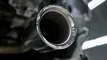 Closeup of clean car muffler. New generation of sportive mufflers. Double Car Exhaust Pipe chromed made of stainless steel. Powerful exhaust pipe from the car.