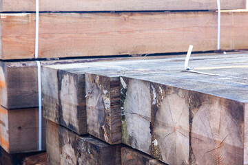 Logging on an industrial scale. Warehouse of wooden blocks. Warehousing of wooden beams.