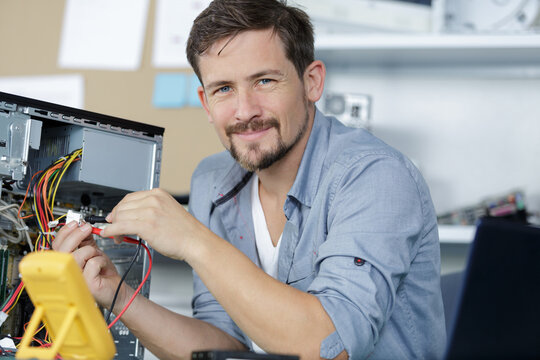 happy computer repair technician repairing hardware