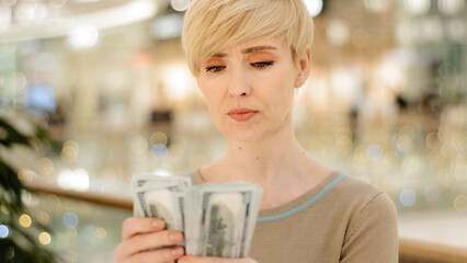 Headshot caucasian middle aged rich woman counting money checking cash salary bonus serious businesswoman with financial payment count bribe holding dollars bills dollar banknotes with lottery income