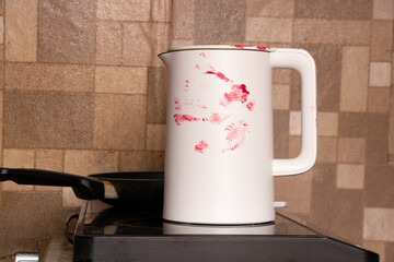 White kitchen kettle in the blood stolen by Russian thieves from the Ukrainian house during the war, household appliances in the blood of a Ukrainian, Russian thieves soldiers