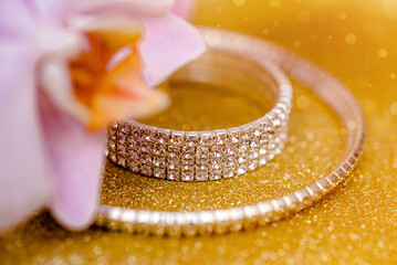 Bracelet and necklace on a gold shiny background
