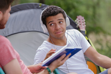 men sitting in front of tent