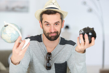 man holding piggy bank and earth globe