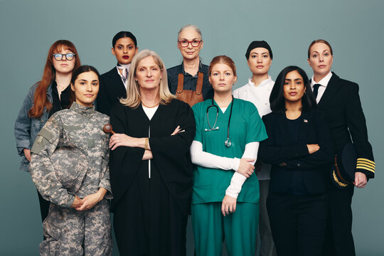 Portrait of different female workers standing in a studio