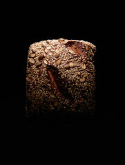 Tasty farmers bread loaf in dark studio