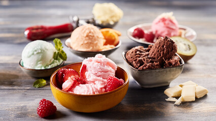 Tasty ice cream scoops in bowls on table