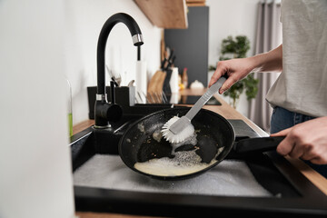 Close up of caucasian woman washing the pans