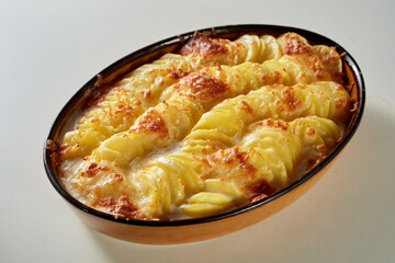Tasty dish with sliced potato and cheese in pan