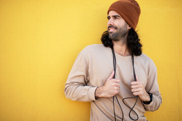 Young thirsty athletic man outside. Fit handsome man resting after training.