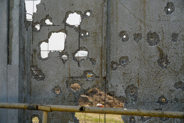 Holes in the fence after mortar shelling