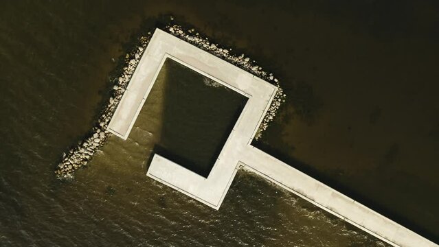 Aerial shot of Ventės Ragas jetty. Camera over the top going down, Lithuania, Ventė. 4K 25fps