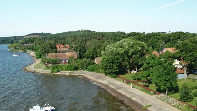 Aerial shot of Preila village curonian lagoon, local houses. Lithuania, Preila. 4K 25fps