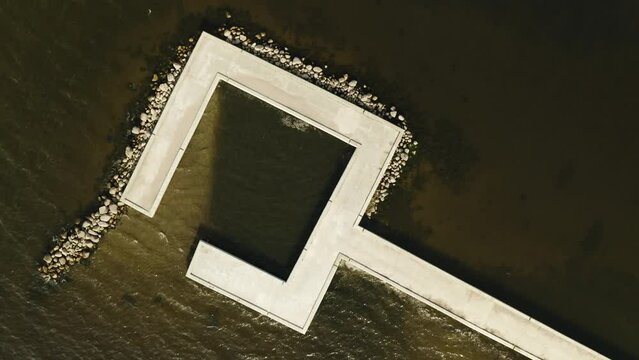 Aerial shot of Ventės Ragas jetty. Camera over the top going up. Lithiania, Ventė. 1 4K 25fps