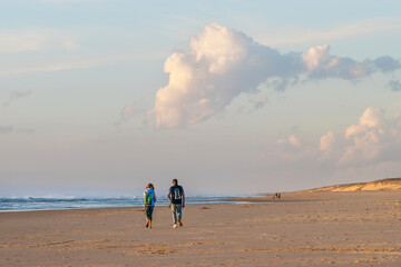 Couple walking at sunset along Des Sablères Beach. Vieux-Boucau. Landes