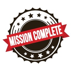 MISSION COMPLETE text on red brown ribbon stamp.