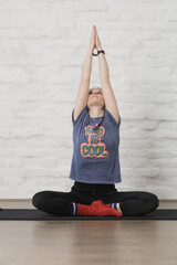 Young woman practicing meditation and breathing exercises. Wellbeing and self care concept.