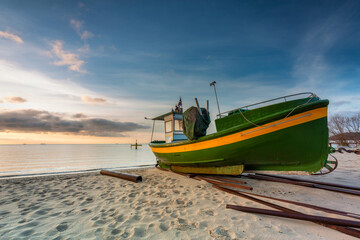 Beautiful landscape of the beach with fishing boats at sunrise in Gdynia Orlowo. Poland