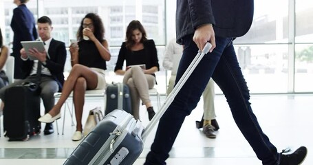 Ambition takes you places. Young business man on business trip walking with his luggage in front of a group of waiting people. Travelling businessman headed towards terminal in a modern airport - Powered by Adobe