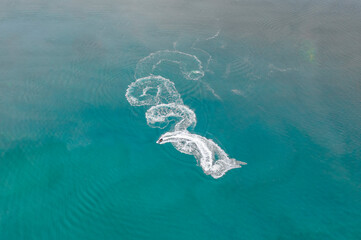 Boats and speedboats on the surface of the sea