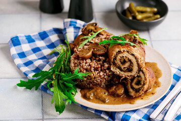 Beef rolls with mushrooms and sauce. rustic style