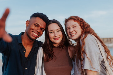 Three diverse friends smiling at the camera