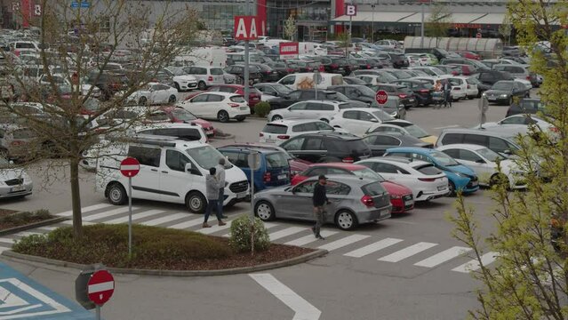 busy shoppers and traffic at full shopping mal parking lot