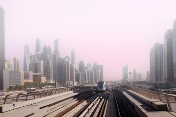Fototapeta na wymiar Dubai metro railway in downtown district with buildings and skyscrapers. United Arab Emirates. Panoramic view