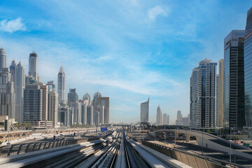 Fototapeta na wymiar Dubai metro railway in downtown district with buildings and skyscrapers. United Arab Emirates. Panoramic view
