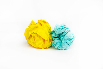 two wads of crumpled yellow and blue paper on a white background as symbols of Ukraine,
