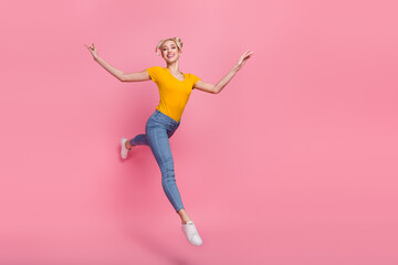 Full size photo of attractive girl jumping go walk enjoy spring weekend traveling isolated on pink color background