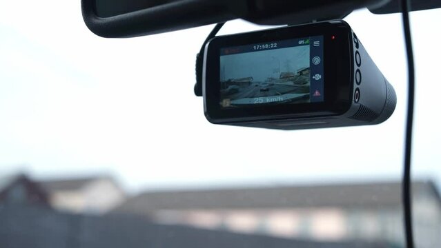 The DVR works in the car. Video recording of the traffic situation while driving. The car is moving along a busy highway