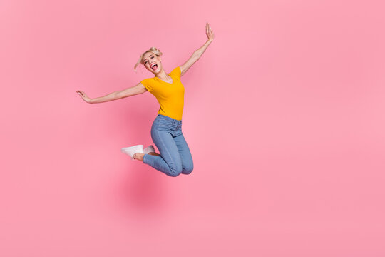Full size photo of attractive pretty woman jumping fooling around enjoy free summer time isolated on pink color background