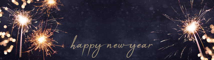 HAPPY NEW YEAR 2023 background banner panorama greeting card, celebration holiday Silvester Party - Festive sparkling sparklers, bokeh lights and fireworks, on blue dark night texture