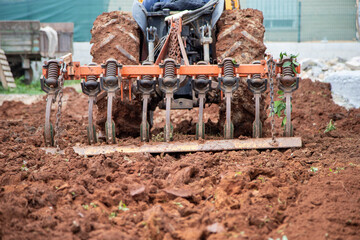 tractor plowing the field to proceed with vegetable planting