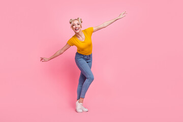Full size photo of funky blond lady dance wear t-shirt jeans sneakers isolated on pink color background