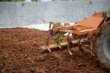 tractor plowing the land to prepare the garden for the summer