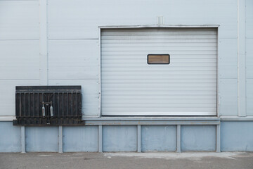 Obraz na płótnie Canvas Facade of modern warehouse with gate and lift