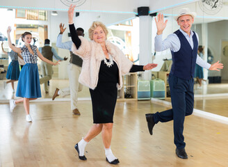 Mature woman dancing swing with young man