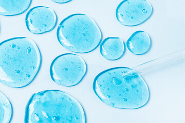 Gel transparent drops forming a background and a pipette. The concept of protection against viruses...
