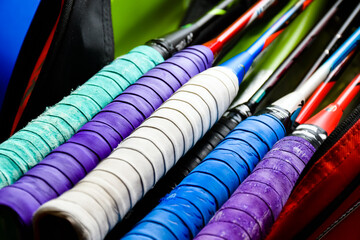 Closeup view of badminton rackets which are in the badminton's bag, soft and selective focus on handles and grips.
