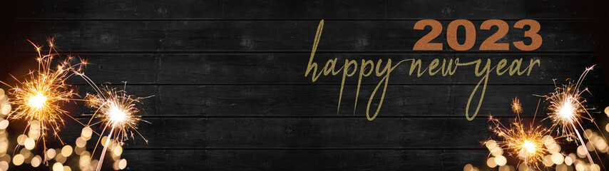 bokeh golden flares and sparkler isolated on rustic black wooden texture - Holiday New Year's Eve...