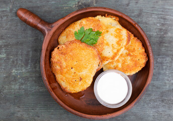 Potato pancakes with sour cream closeup. Belorussian cuisine