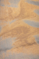 Fototapeta na wymiar texture of sand on asphalt. Patterns of wind-blown dry sand on an asphalt road