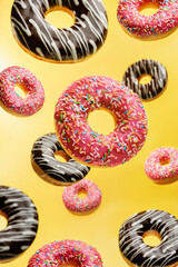 glazed donuts levitating on a yellow background.