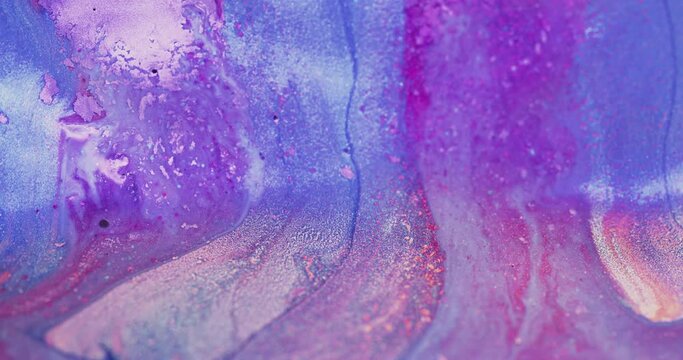 Glitter ink flow. Color fluid mix. Floating shiny liquid. Defocused iridescent purple pink blue shimmering wet paint motion abstract art background shot on RED Cinema camera.