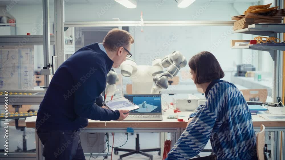 Poster male promising computer scientist and his professor use programmable robot hand, manipulate it with 