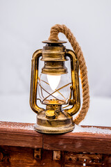 Vintage lantern stands outside in winter