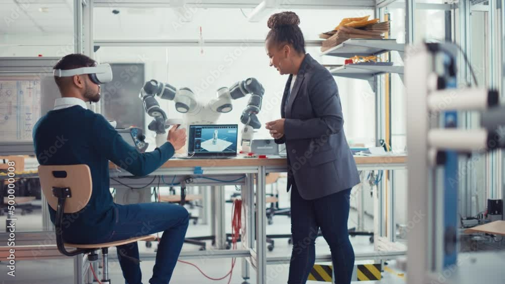 Leinwandbilder black senior engineer talks to young male computer scientist wearing virtual reality headset uses co